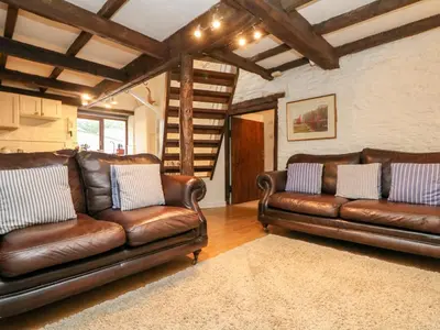 two brown leather couches in a living room at Apple Loft in Lostwithiel