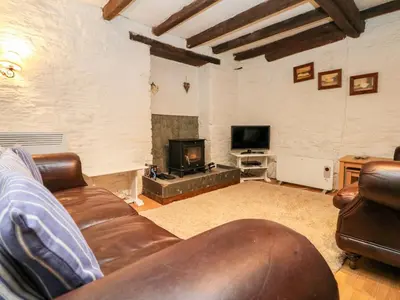 a living room with a couch and a tv at Apple Loft in Lostwithiel