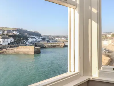 a window with a view of a body of water at Haven in Helston