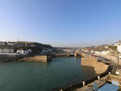 a view of a river with a bridge and buildings at Haven in Helston