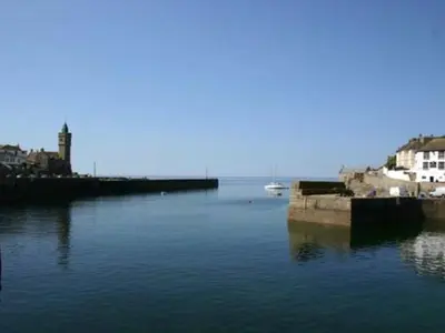 a large body of water with houses and buildings at Pegs in Porthleven