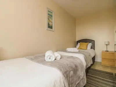 a bedroom with two beds with towels on them at Sea Horses in Marazion