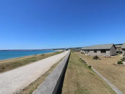 an empty road next to a house and the water at Sea Horses in Marazion