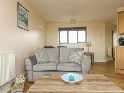 a living room with a couch and a table at Sea Horses in Marazion