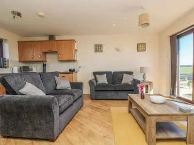 a living room with a couch and a table at Surfside in Marazion