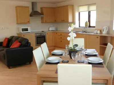 a kitchen and dining room with a table and chairs at Sea Shore in Marazion