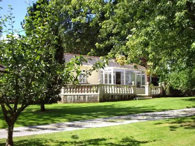 a house with a porch and a lawn at Trelaze in Wadebridge