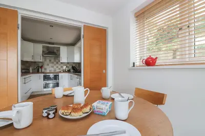 a kitchen with a table with a plate of food on it at Rock Pool in Downderry