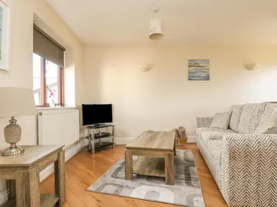 a living room with a couch and a table at Seabreeze in Marazion