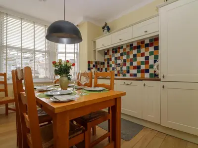 a kitchen with a wooden table and a dining room at Mount View in Marazion