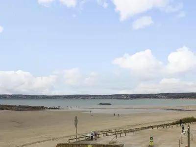 a view of a beach with people in the water at Mount View in Marazion