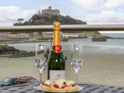 a bottle of wine on a table with two glasses at Mount View in Marazion