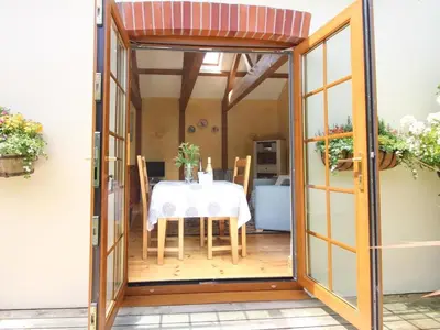 a dining room with a table with a white table cloth at Summer House in Helston
