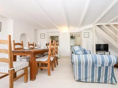 a dining room with a table and chairs at Mallards in Pentewan