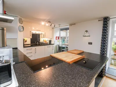 a kitchen with a counter with a chopping board on it at Ebenezer Cottage in Marazion