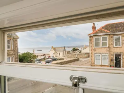 a window with a view of a street at Ebenezer Cottage in Marazion