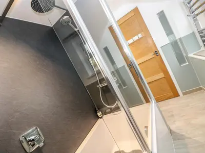 a shower with a glass door in a bathroom at Ebenezer Cottage in Marazion