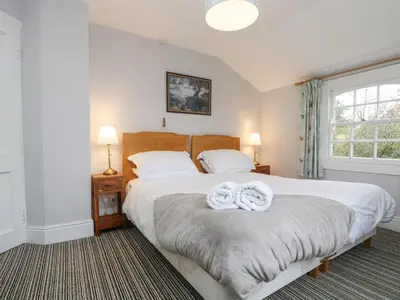 a bedroom with a bed with two towels on it at Trenouth Cottage in Padstow
