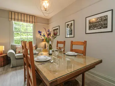 a dining room with a table and chairs at Penwarne Lodge in Budock Water