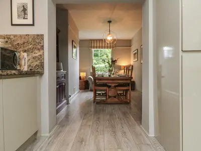 a hallway with a table and a dining room at Penwarne Lodge in Budock Water