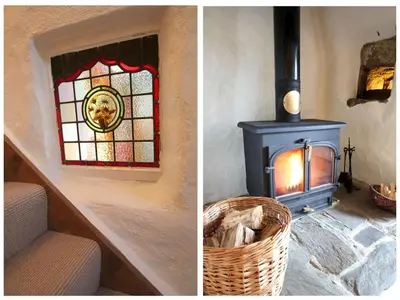 a room with a fireplace and a stained glass window at Rose Cottage in Helston
