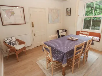 a dining room with a table and chairs at Banneth in Mawgan