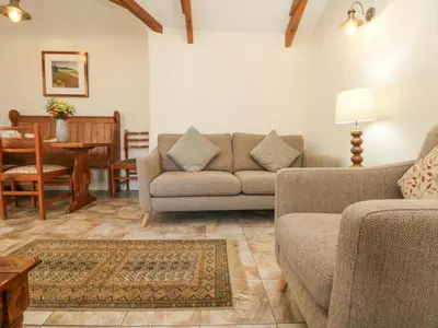 a living room with two couches and a table at Roosters in Lostwithiel