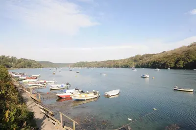 a bunch of boats are docked in the water at Byre in Lostwithiel