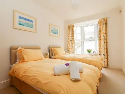 two beds sitting next to each other in a bedroom at Seabien in Falmouth