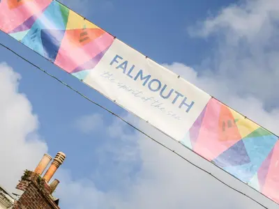 a banner with the word rainforth hanging from a building at Seabien in Falmouth