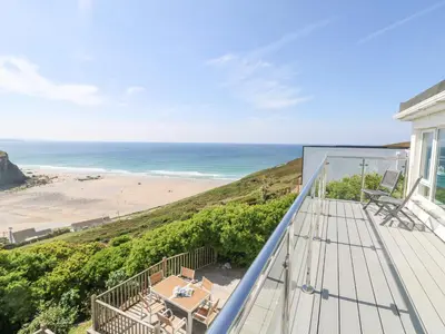 a balcony with a view of a beach at St Ives View in Porthtowan
