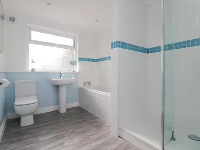 a bathroom with a toilet and a sink and a shower at St Ives View in Porthtowan