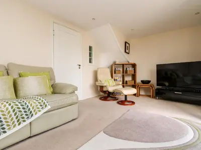 a living room with a couch and a flat screen tv at Riverview in Lostwithiel