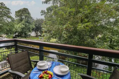 a table with a bowl of fruit on a balcony at Riverview in Lostwithiel