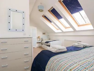 a bedroom with two twin beds and skylights at Riverview in Lostwithiel