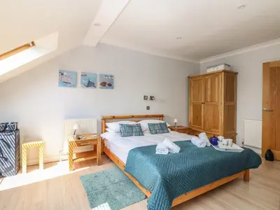 a bedroom with a bed and a desk in a room at Tides in Padstow
