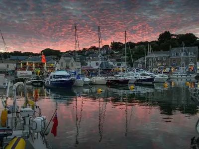 a group of boats docked in a marina at sunset at Tides in Padstow