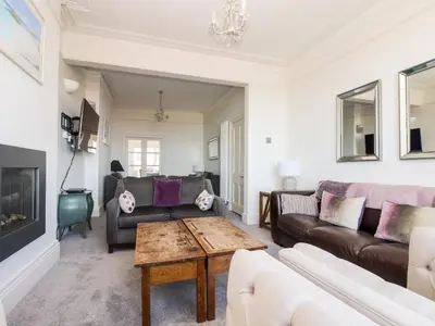a living room with a couch and a table at Porthmeor Beach House in St Ives
