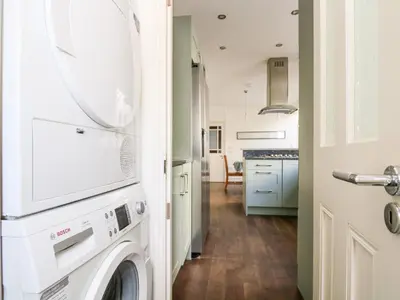 a laundry room with a washer and dryer at Porthmeor Beach House in St Ives