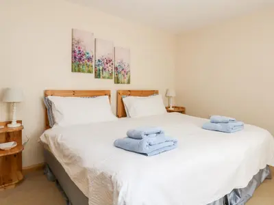 a bedroom with a bed with towels on it at Mynheer Farm Bowji in Redruth