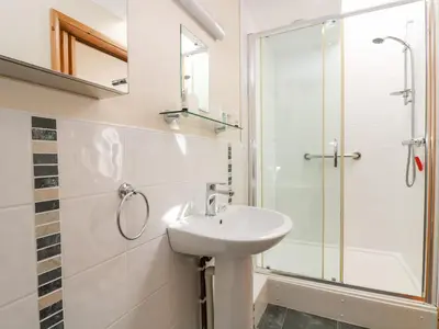 a bathroom with a sink and a shower at Mynheer Farm Bowji in Redruth