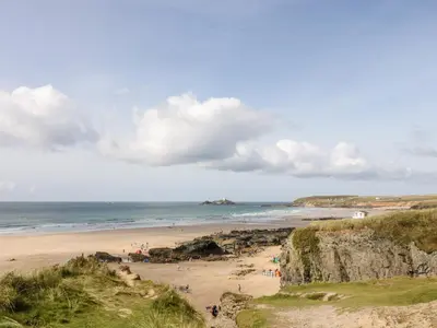 a beach with people on the sand and the ocean at Mynheer Farm Bowji in Redruth