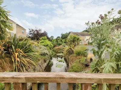 a view of a river from a wooden bridge at Rosemary Cottage in Falmouth