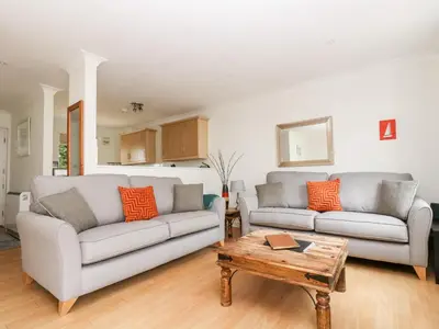 a living room with two couches and a coffee table at Rosemary Cottage in Falmouth