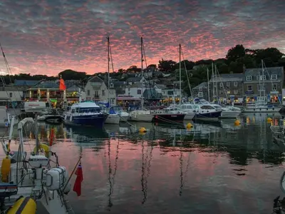 a group of boats docked in a marina at sunset at Windrush in Newquay