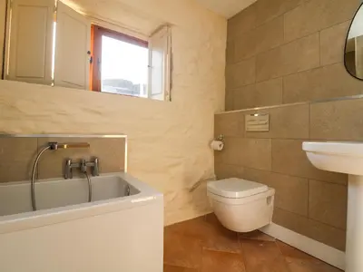 a bathroom with a tub and a toilet and a sink at Marhayes in Camelford