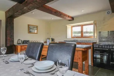 a kitchen with a table with two chairs and a table sidx sidx sidx at Marhayes in Camelford
