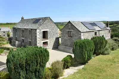 an old stone house with solar panels on it at Marhayes in Camelford