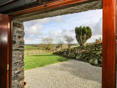 a view through the door of a stone gate into a yard at Westhayes in Camelford