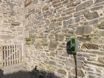 a brick wall with a green phone attached to it at Westhayes in Camelford